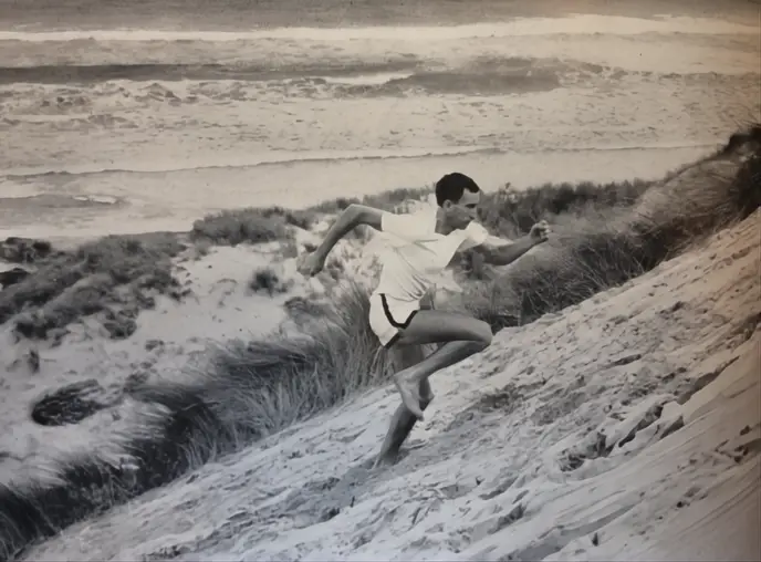 Herb Elliott running up sand dune